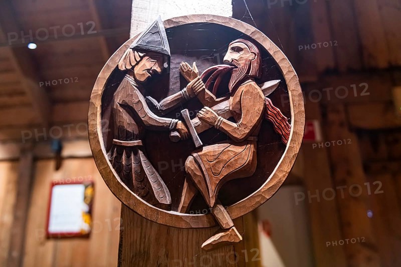 Wooden sculptures in a reconstructed long house in the Lofotr Viking Museum