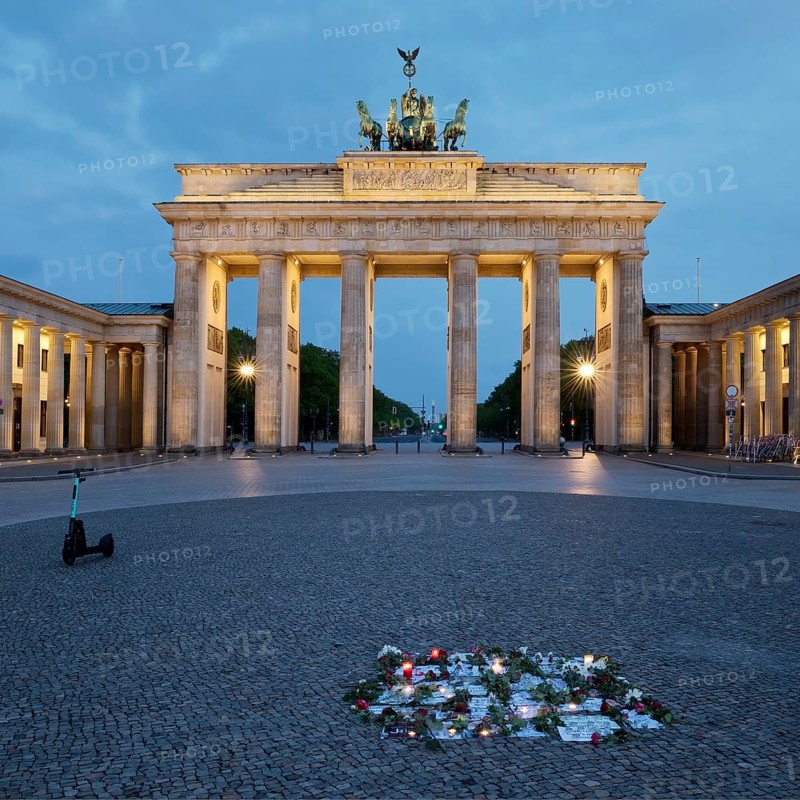 Brandenburg Gate with silent protest and parked e-scooter on Pariser Platz in the early morning