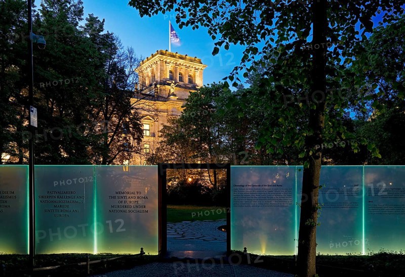 Memorial to the Sinti and Roma of Europe murdered under National Socialism with the Reichstag illuminated in the evening