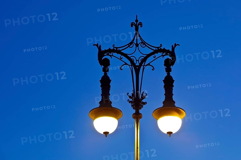 Shining old Berlin gas lantern in the evening