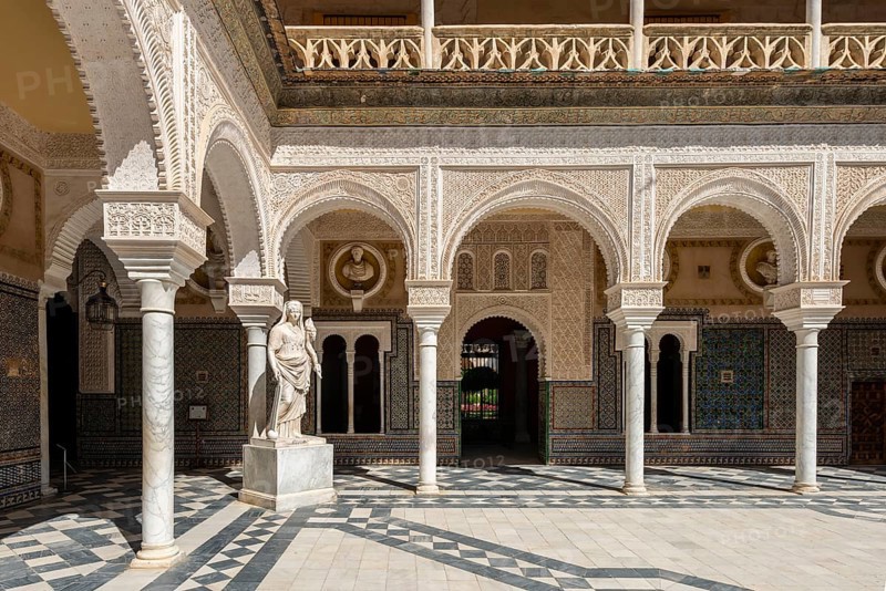 Statue in the courtyard with arches