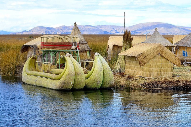 Typical reed boats and reed huts on a floating island of the Uro