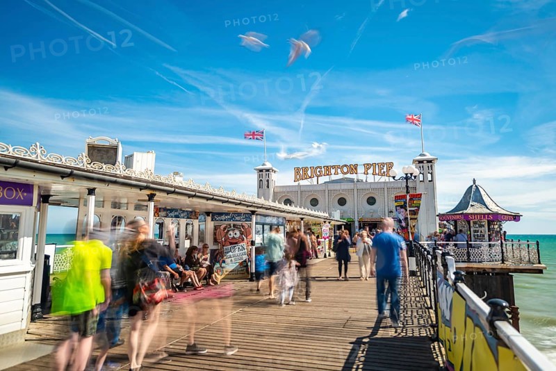 Tourists at Brighton Palace Pier with seagulls