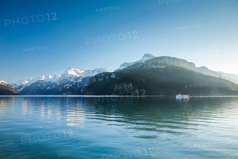 View from Brunnen on a boat on the Lake of Uri in front of the mountain scenery of the Alps of Uri