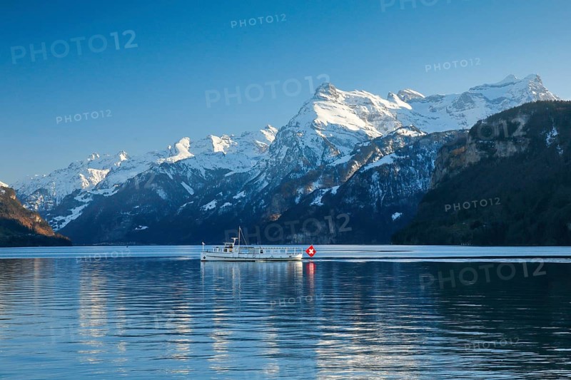View from Brunnen on a boat on the Lake of Uri in front of the mountain scenery of the Alps of Uri