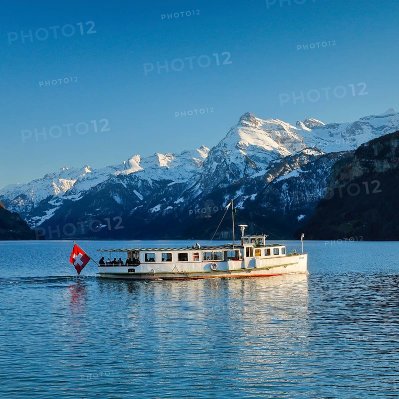 View from Brunnen on a boat on the Lake of Uri in front of the mountain scenery of the Alps of Uri