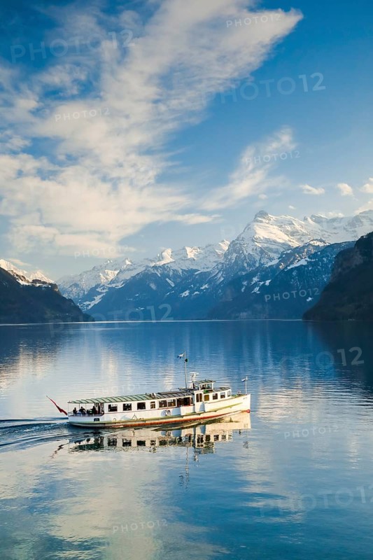 View from Brunnen on a boat on the Lake of Uri in front of the mountain scenery of the Alps of Uri