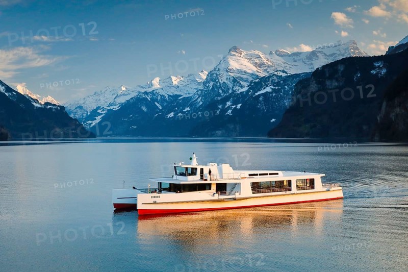 View from Brunnen on a boat on the Lake of Uri in front of the mountain scenery of the Alps of Uri
