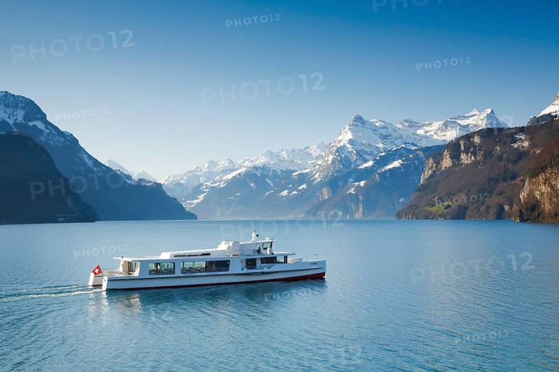 View from Brunnen on a boat on the Lake of Uri in front of the mountain scenery of the Alps of Uri
