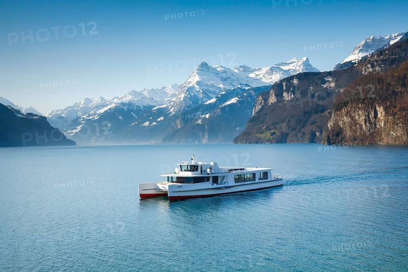 View from Brunnen on a boat on the Lake of Uri in front of the mountain scenery of the Alps of Uri