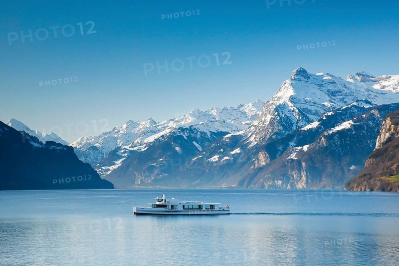 View from Brunnen on a boat on the Lake of Uri in front of the mountain scenery of the Alps of Uri