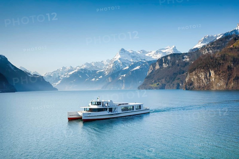 View from Brunnen on a boat on the Lake of Uri in front of the mountain scenery of the Alps of Uri