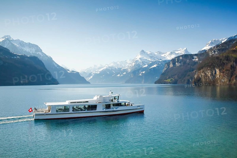 View from Brunnen on a boat on the Lake of Uri in front of the mountain scenery of the Alps of Uri