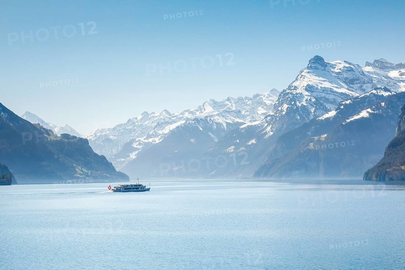 View from Brunnen on a boat on the Lake of Uri in front of the mountain scenery of the Alps of Uri