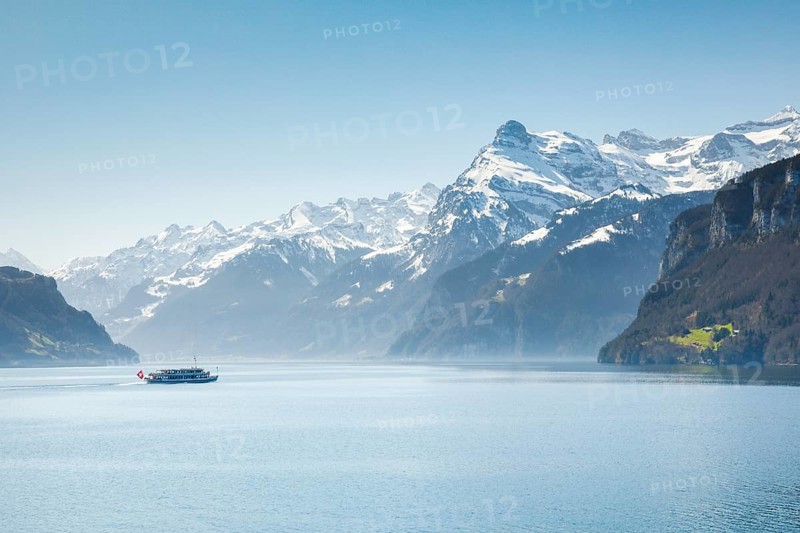 View from Brunnen on a boat on the Lake of Uri in front of the mountain scenery of the Alps of Uri