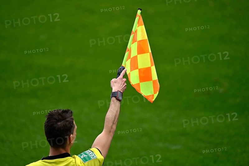 Linesman indicates offside position with flag