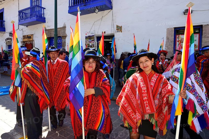 Group with flags in ponchos in the old town