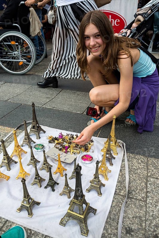 Girl buys Eiffel Tower model as souvenir
