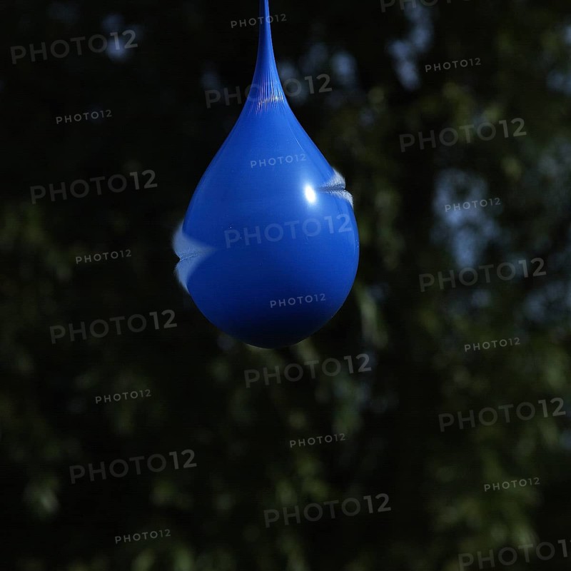 Exploding blue balloon with water inside