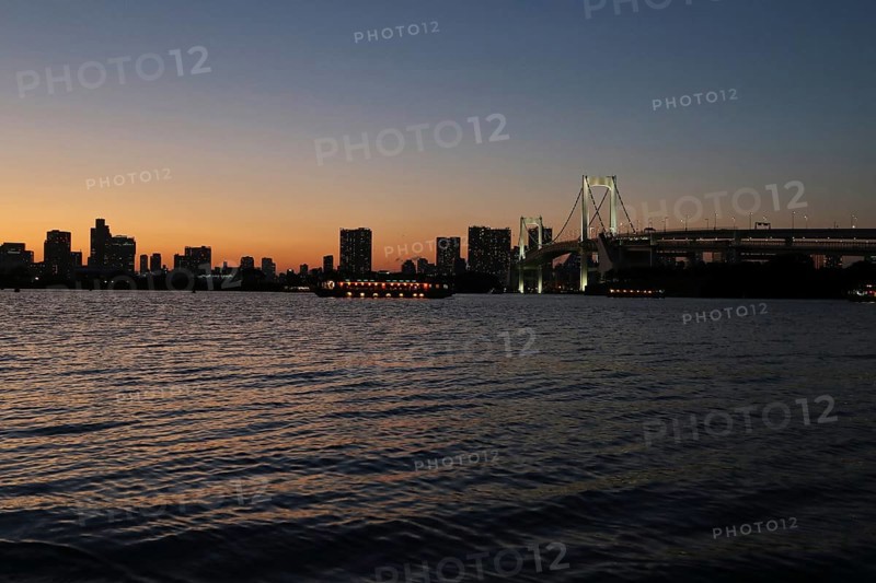 View from Odaiba Beach to Tokyo Bay with Rainbow Bridge at dusk
