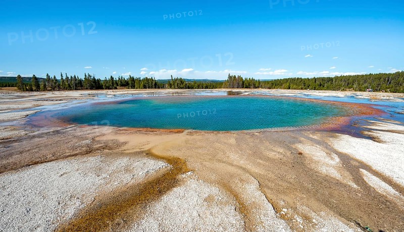 Steaming hot spring with colored mineral deposits