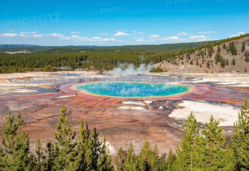 Steaming hot spring with colored mineral deposits and turquoise water
