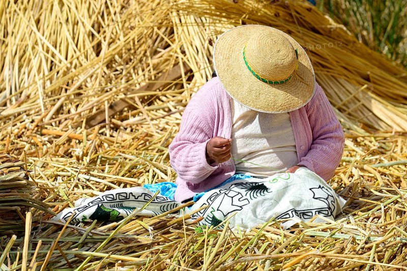 Indigenous woman embroidering on a Uro floating island