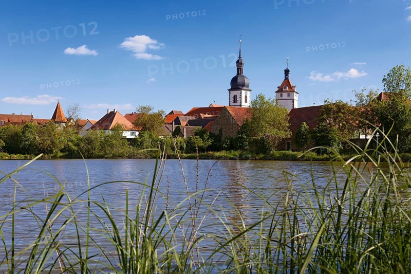 View over the Breiter See lake to the old town with the church St. Sixstus and the town tower