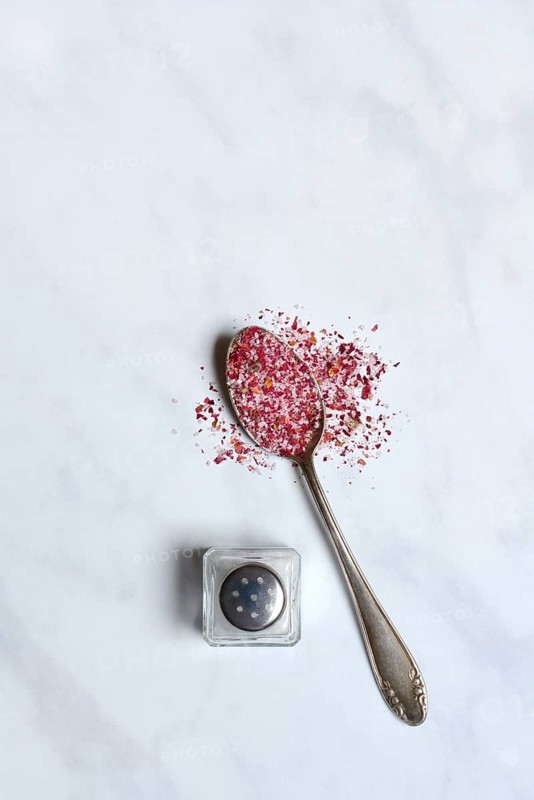 Rose salt in spoon and salt shaker
