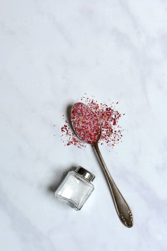 Rose salt in spoon and salt shaker