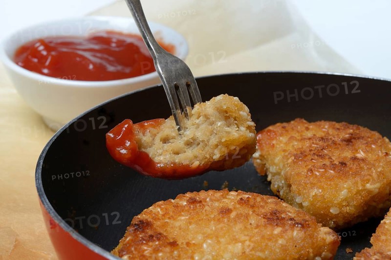 Meat substitute in pan and bowl with ketchup