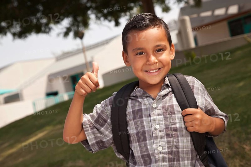 Happy young hispanic school boy with thumbs up one morning