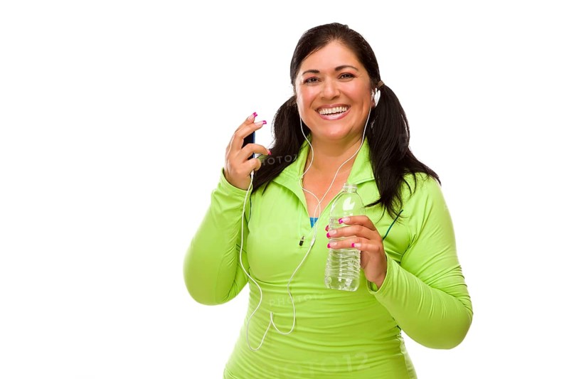 Attractive middle aged hispanic woman in workout clothes with music player