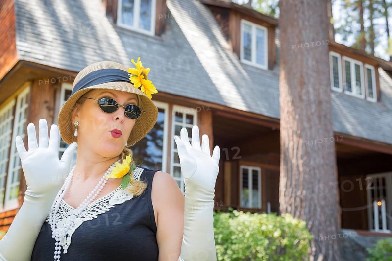 Attractive young woman in twenties outfit near antique house