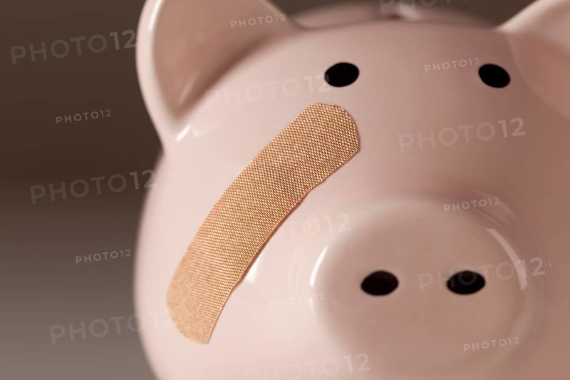 Piggy bank with bandage on face