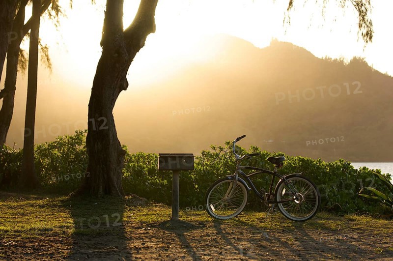 Sunset on hanalei bay with backlit bike and BBQ