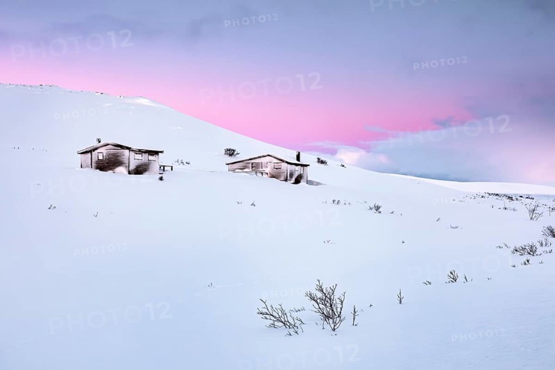 Cabins in winter landscape