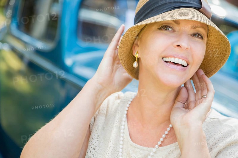 Beautiful 1920s dressed girl near vintage car outdoors portrait