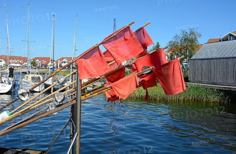 Red fishing flags at the seaside resort of Rerk