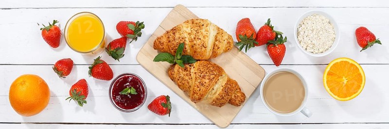 Croissant breakfast croissants food juice orange juice coffee wooden board from above banner in germany