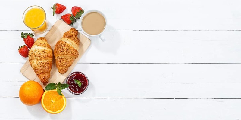Croissant breakfast croissants food juice orange juice coffee wooden board from above text free space copyspace banner in germany