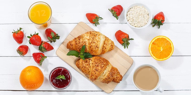 Croissant breakfast croissants food juice orange juice coffee wooden board from above banner in germany