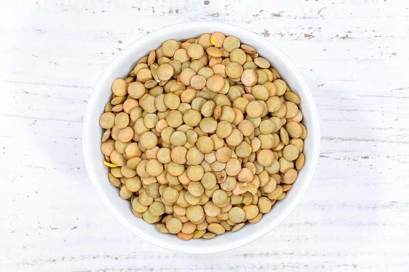 Green lentils raw from top wooden board in Germany