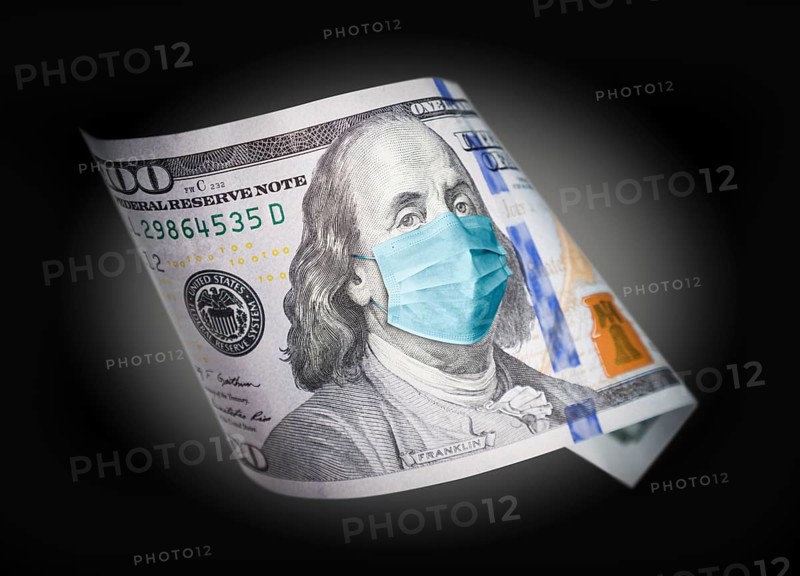 One hundred dollar bill with medical face mask on benjamin franklin