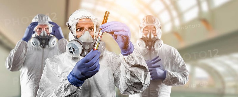 Team of doctors or nurses in hazmat gear holding positive coronavirus test tube banner