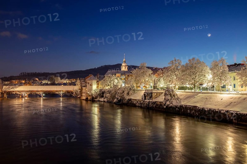 View of river Aare with wooden bridge in winter