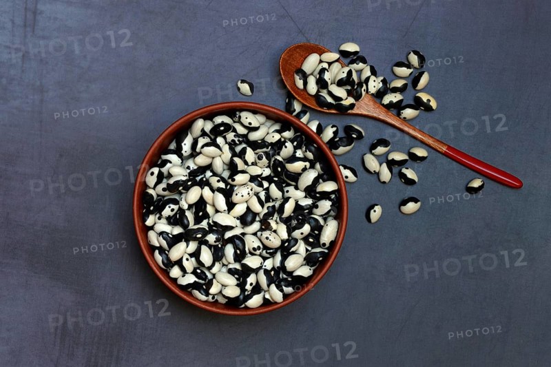 Dried beans in bowl with spoon