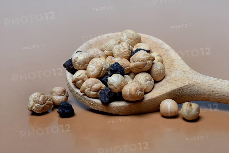 Light and black chickpeas in cooking spoon