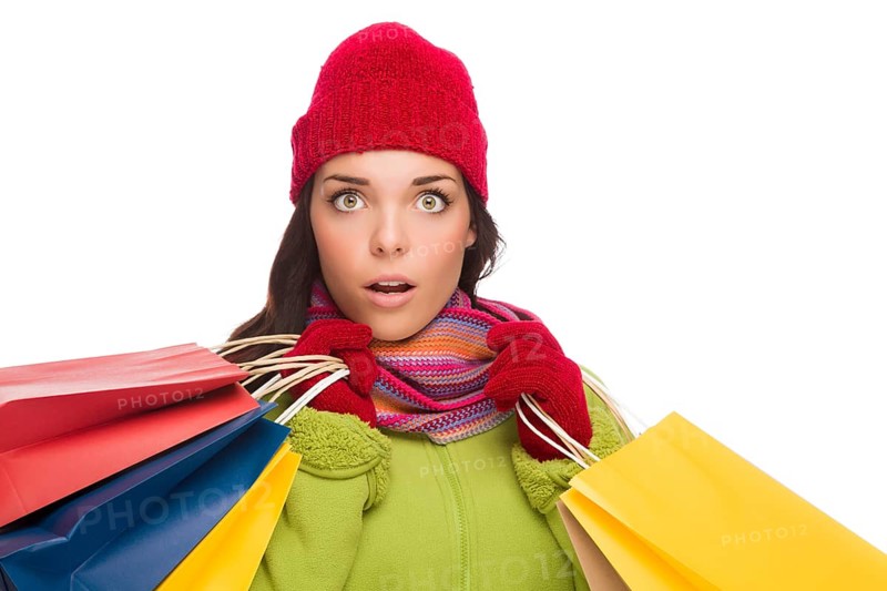 Beautiful mixed-race woman wearing winter hat and gloves isolated on a white background