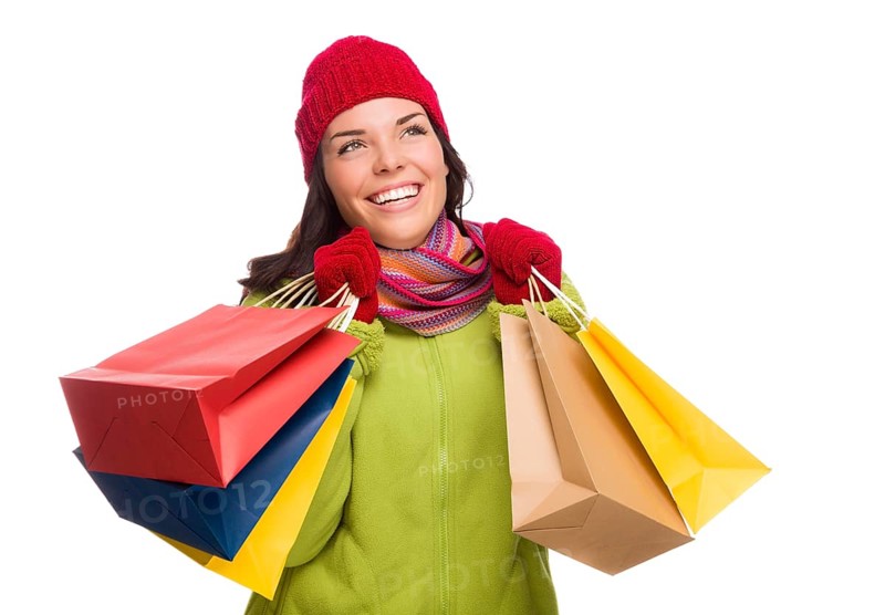 Beautiful mixed-race woman wearing winter hat and gloves isolated on a white background looking to the side